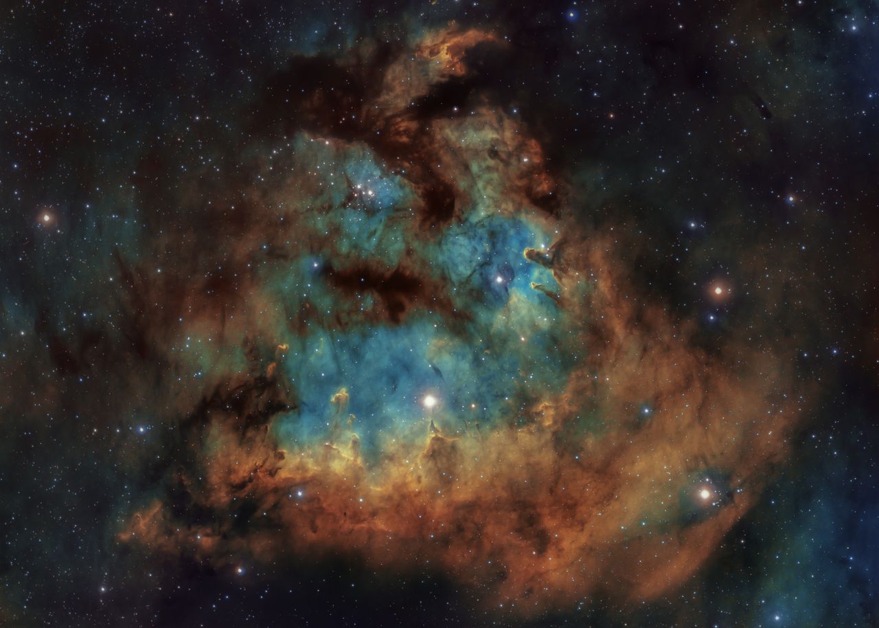 A vivid cosmic nebula with vibrant colors and star field, showcasing the beauty of space.